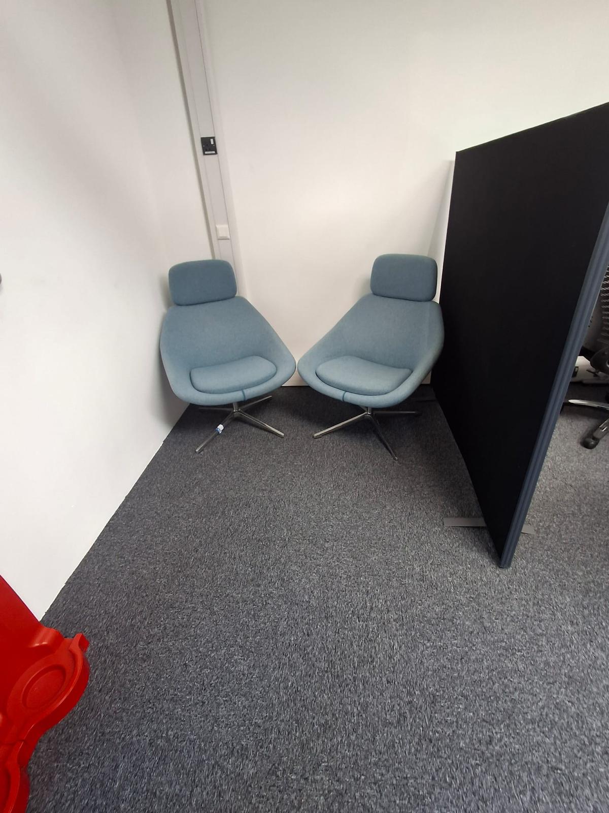 Clean office breakout area with two chairs